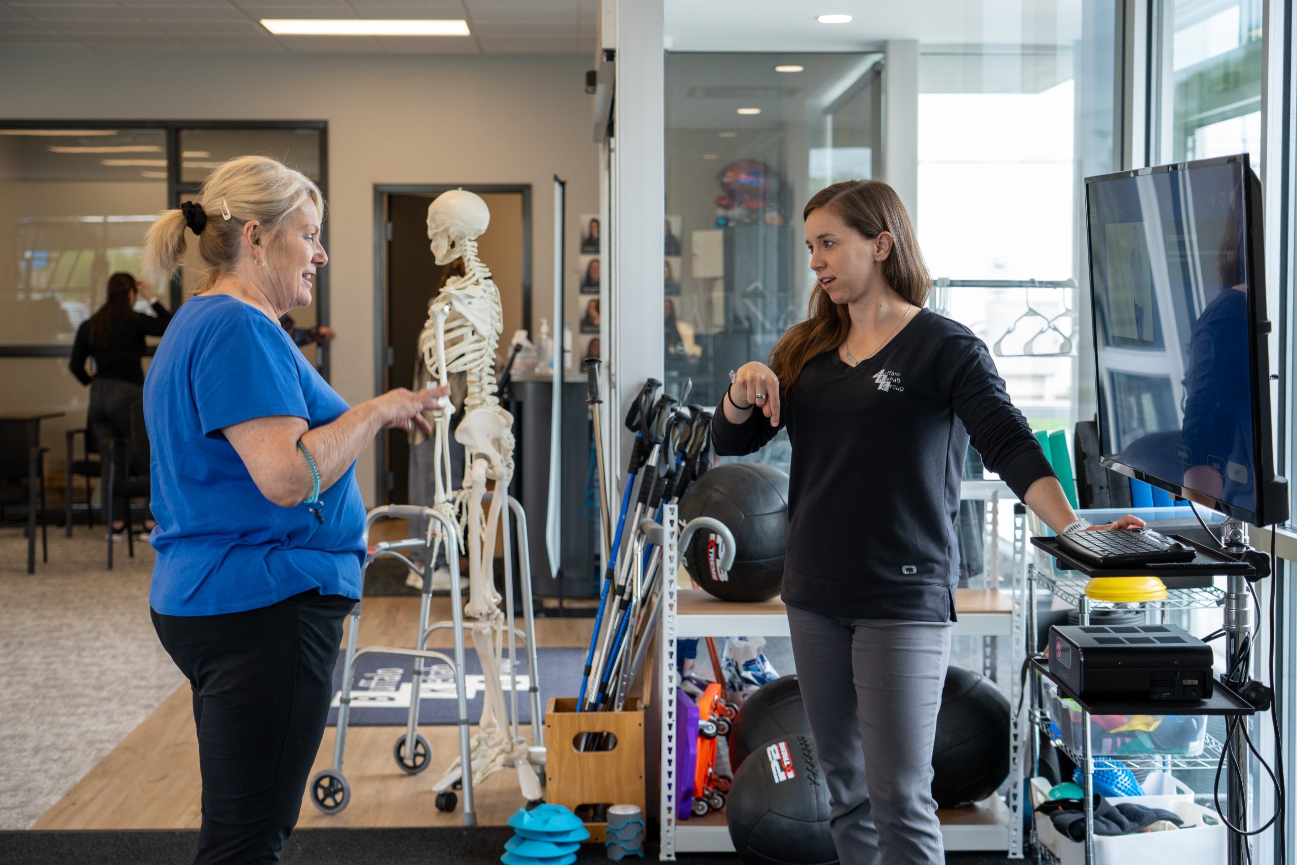 Jake Woodrich, PT DPT CSCS, Laura Rowand, PTA, and Serena Jung, PTA treating their patients at their clinics.