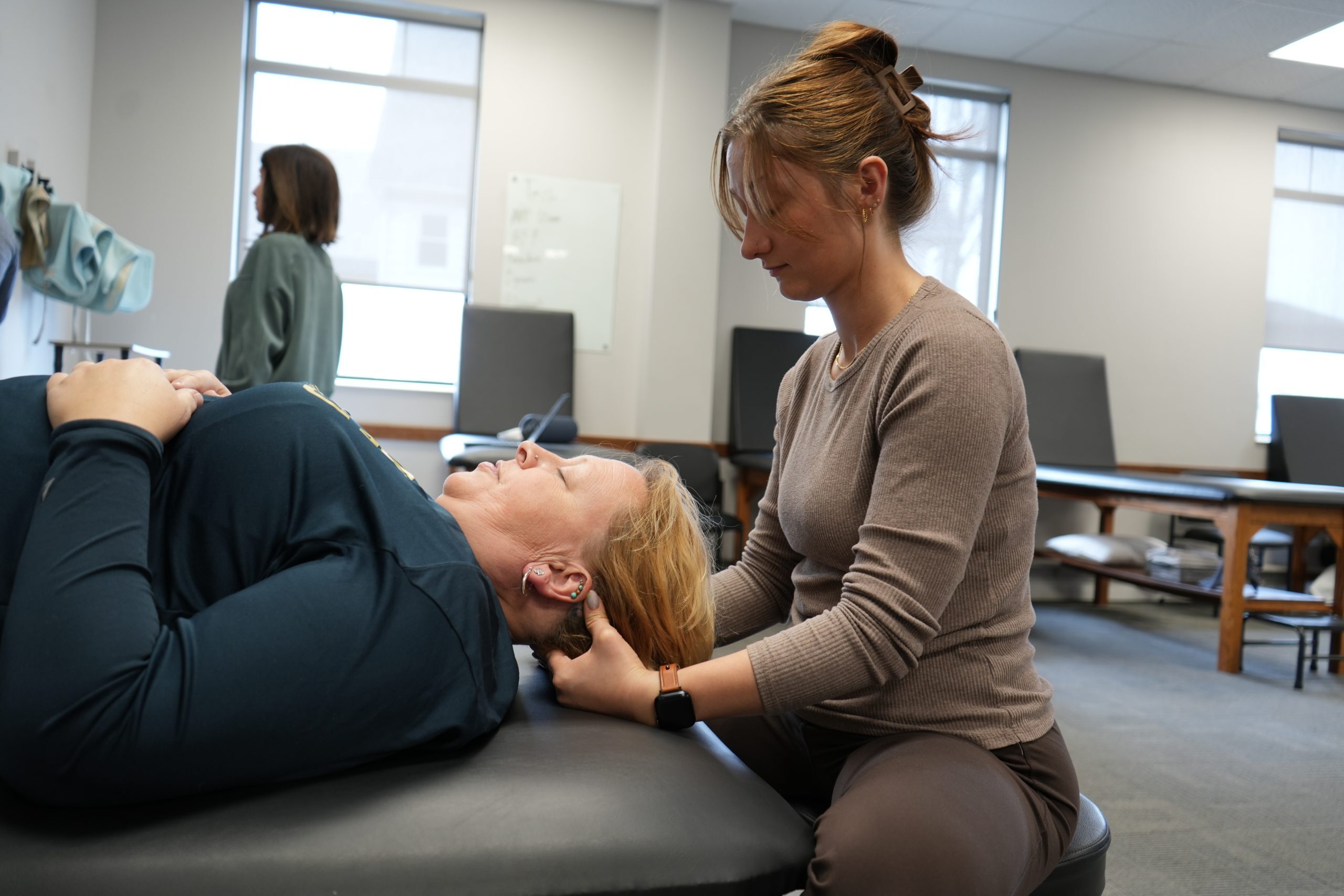 BRG patient Becky, getting her neck worked on by her Physical Therapist Assistant, Ali Hartman at the Buffalo Rehab Group Hamburg - Village location.
