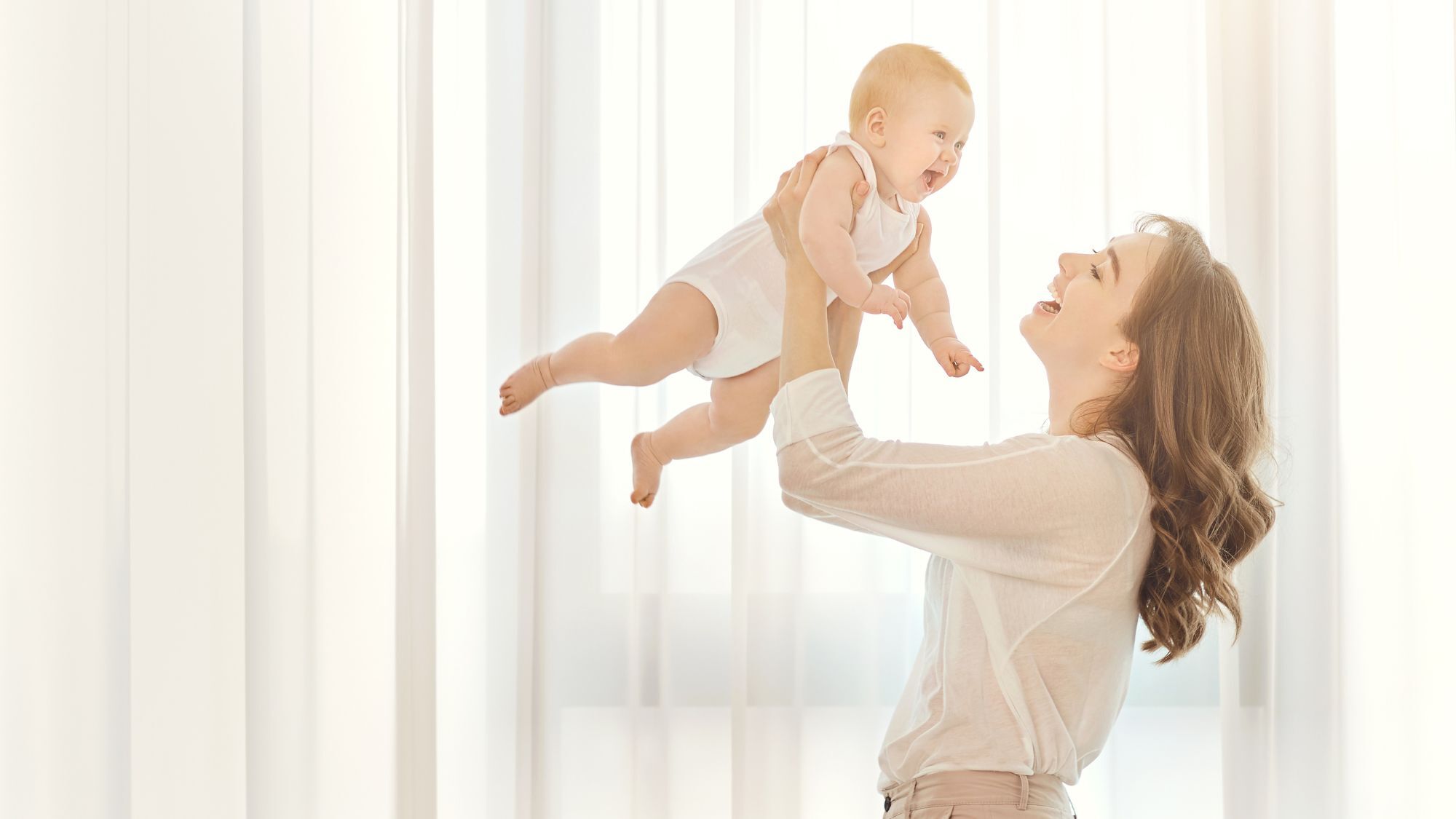 Image of a woman playing with her baby.