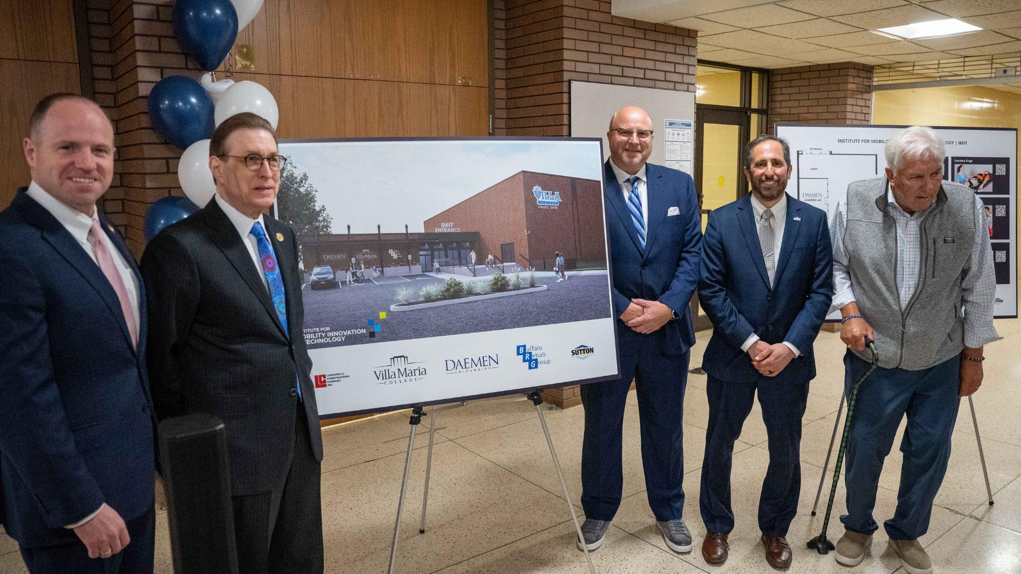 A group of gentleman standing around a poster of a new facility that's being opened.