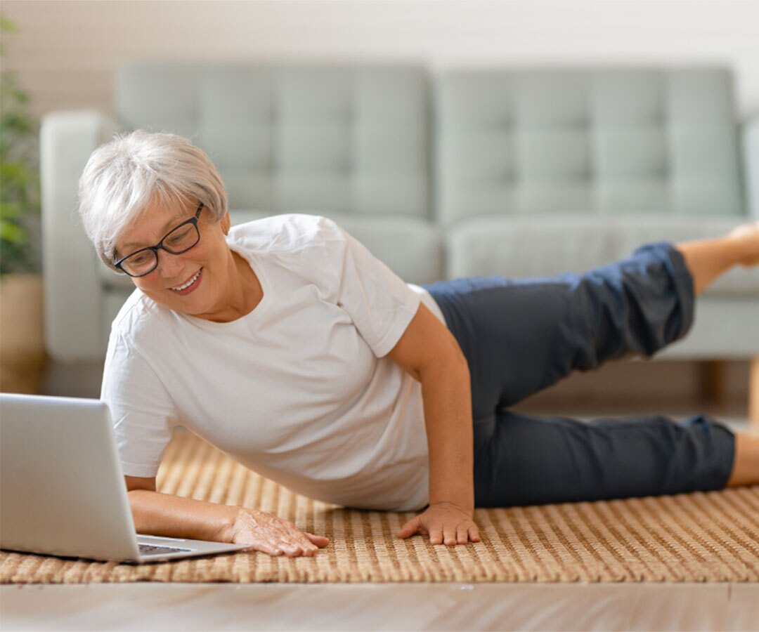An Occupational Therapist smiles as she treats her patient.