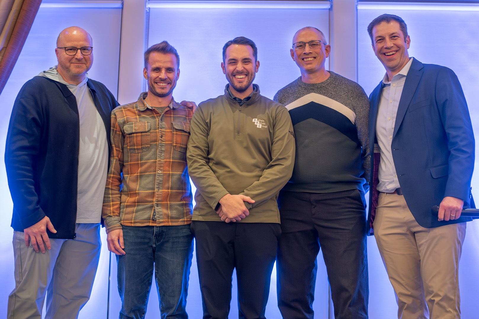 Image of BRG partners Jeff Woodrich, CEO, Steve Gonser, CMO, Ray Hammel, CFO, and Eric Herman, CCO with John Mayer, PT DPT NCS as he accepts his award as the 2025 BRG Impact Winner.