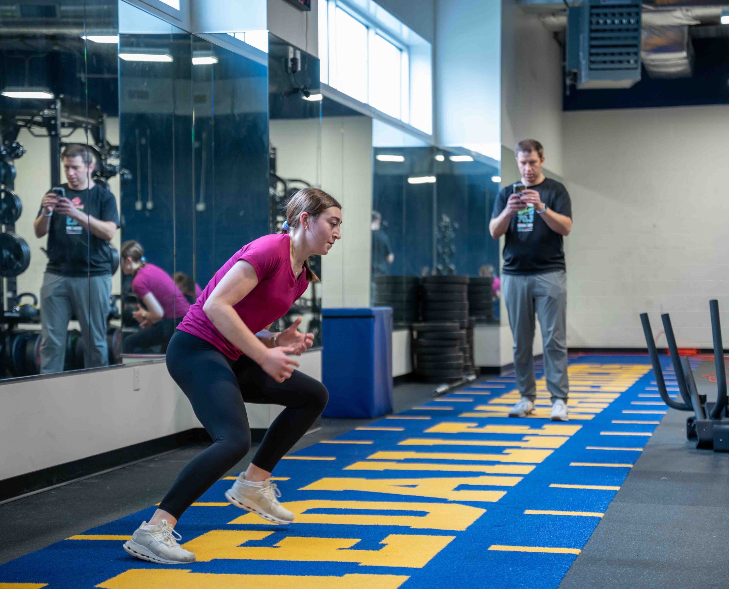 A physical therapist assistant happily converses with her patient.